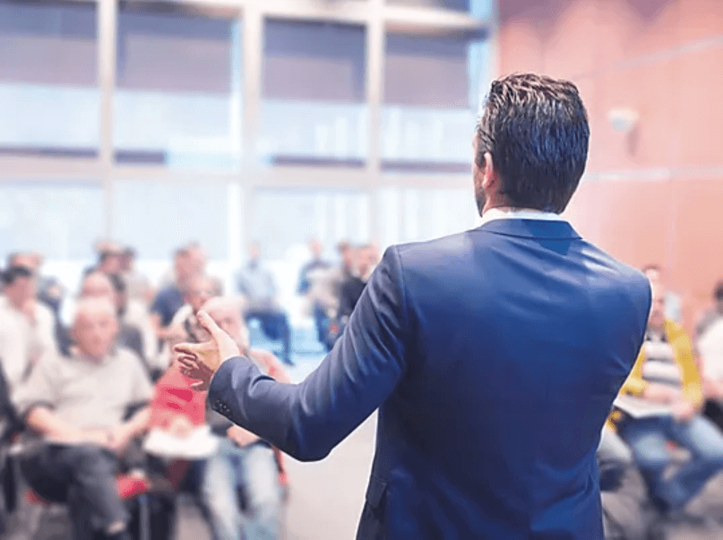 Conference marketing event, speaker facing crowd